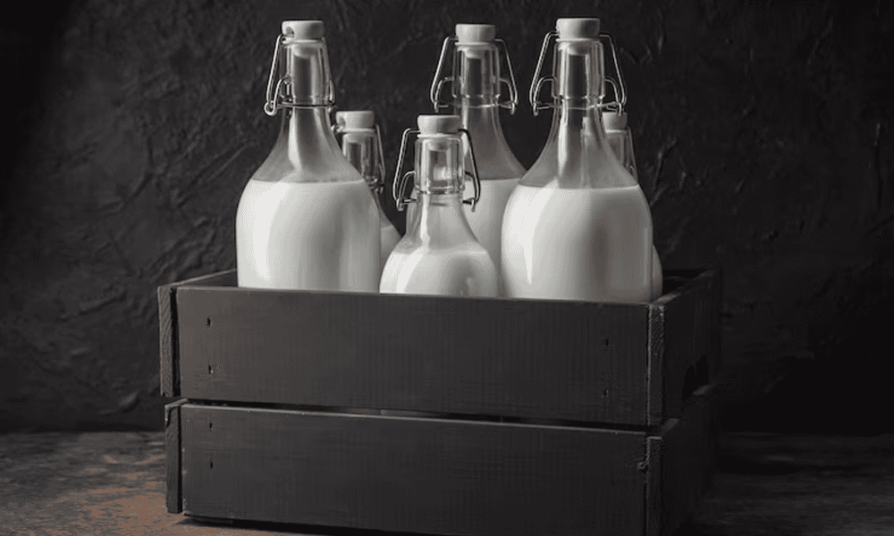 Pure milk bottles in crates, demonstrating pure quality and sanitary values at NK Dairy Equipments