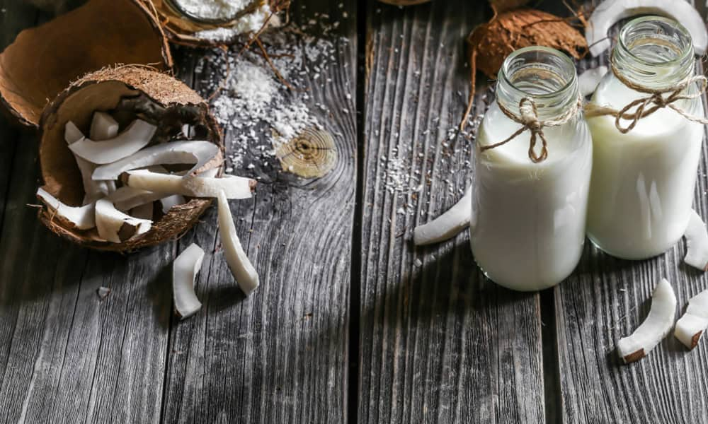 Fresh coconut and coconut milk in glass bottles for dairy products